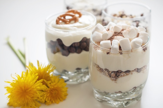 Delicious sweet dessert with cream in a glass on a light background a beautiful breakfast