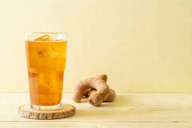 Delicious sweet drink tamarind juice and ice cube. healthy drink style