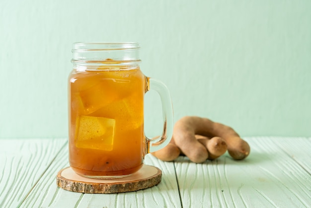 Delicious sweet drink tamarind juice and ice cube - healthy drink style