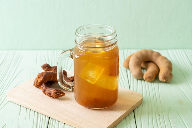 Delicious sweet drink tamarind juice and ice cube - healthy drink style