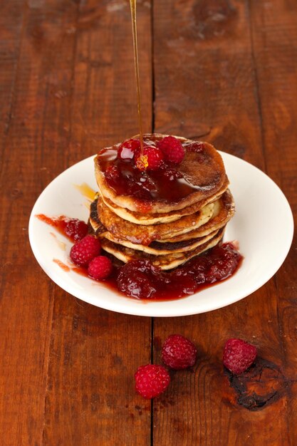 Delicious sweet pancakes on wooden background