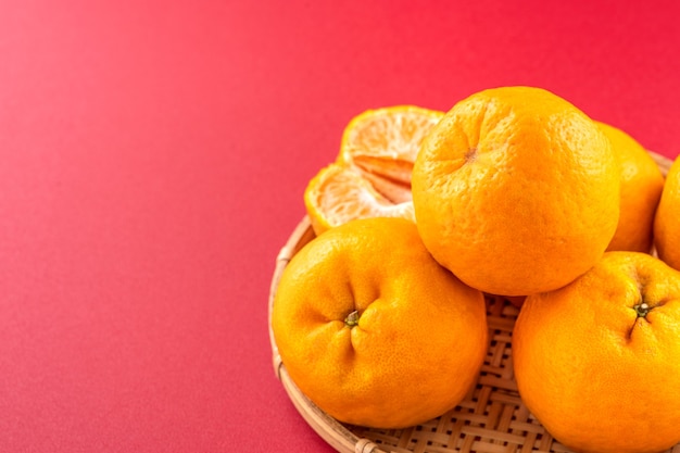 Delicious tangerine isolated on a red background