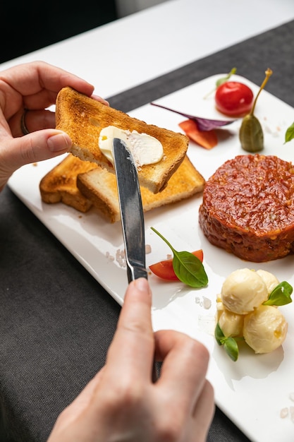 delicious tartar on a white plate with croutons