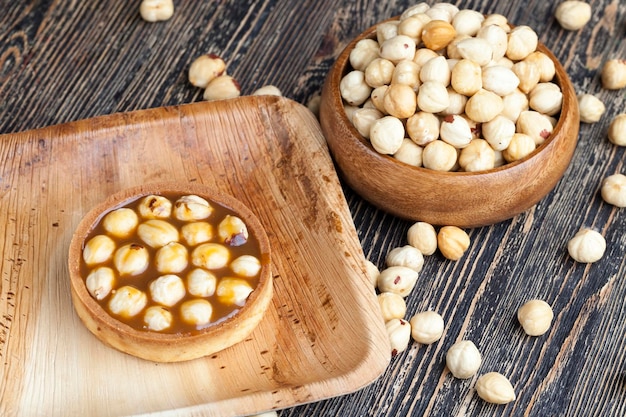 Delicious tartlet cake with soft caramel and roasted hazelnut