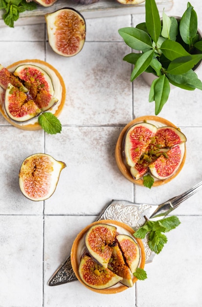 Delicious tartlet with crispy almondflavored pastry delicate cheese cream and figs Autumn dessert