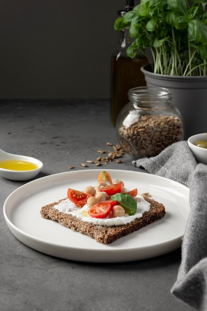 Delicious toast slice with cherry tomatoes on plate