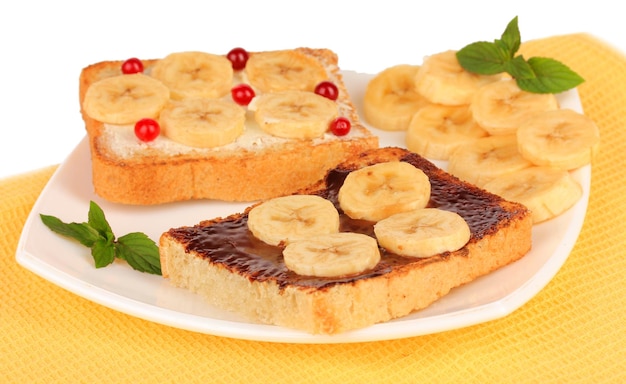 Delicious toast with bananas on plate closeup