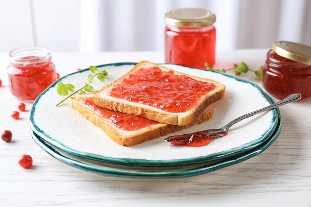 Delicious toasts with sweet jam on plate