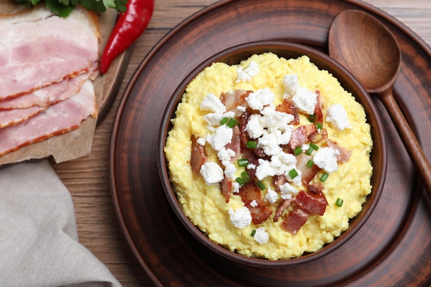 Delicious traditional banosh served on wooden table flat lay