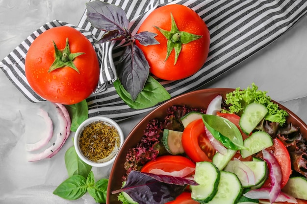 Delicious vegetable salad with cucumbers in bowl on table