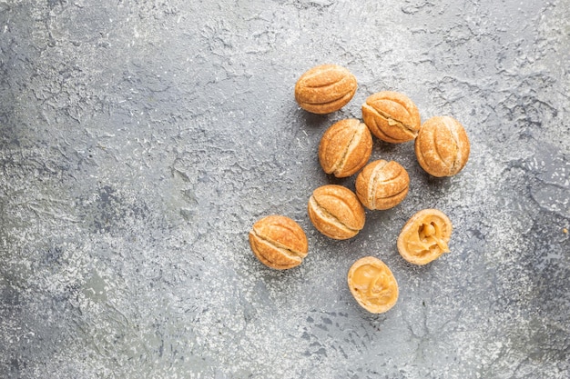 Delicious walnut shaped shortbread sandwich cookies filled with sweet condensed milk, top view