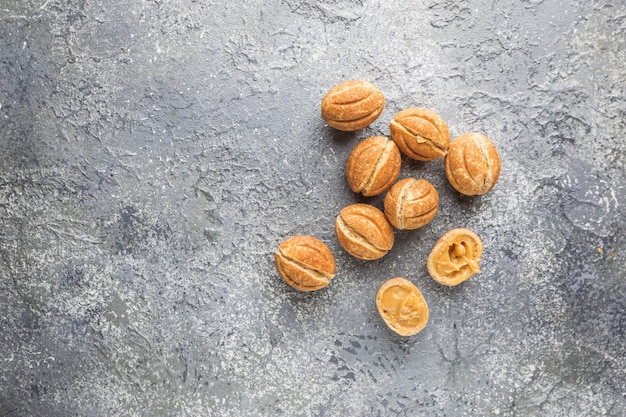 Delicious walnut shaped shortbread sandwich cookies filled with sweet condensed milk, top view