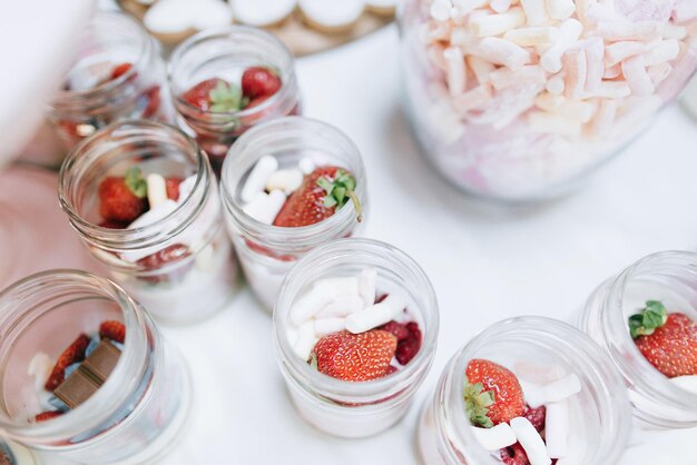 Delicious wedding reception candy bar Dessert table for a wedding party Cakes with raspberries and strawberry jamx9xA