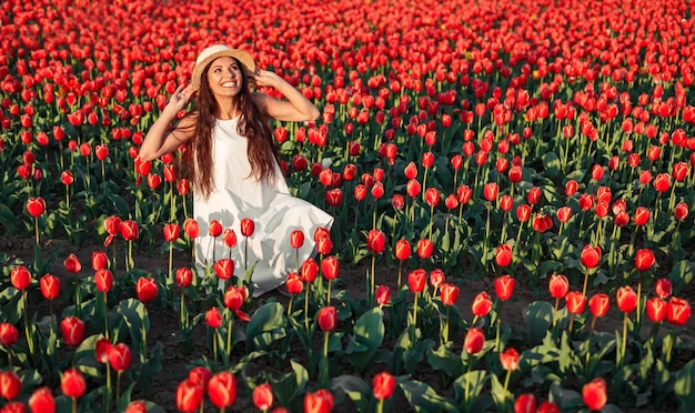 Delighted stylish woman in tulip field