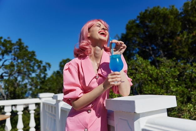 Delighted young girl with pink hair summer cocktail refreshing drink Drinking alcohol