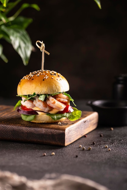 Delisious burger with shrimps on a wooden board