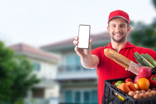 Delivery boy holding food and show mobile phone for customer