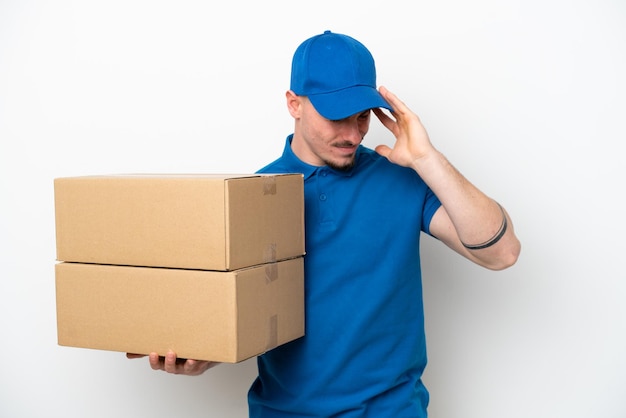 Delivery caucasian man isolated on white background with headache