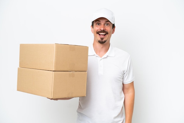 Delivery caucasian man isolated on white background with surprise facial expression