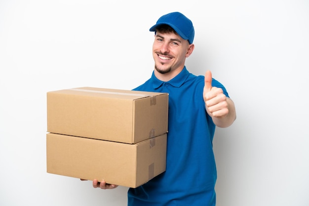 Delivery caucasian man isolated on white background with thumbs up because something good has happened