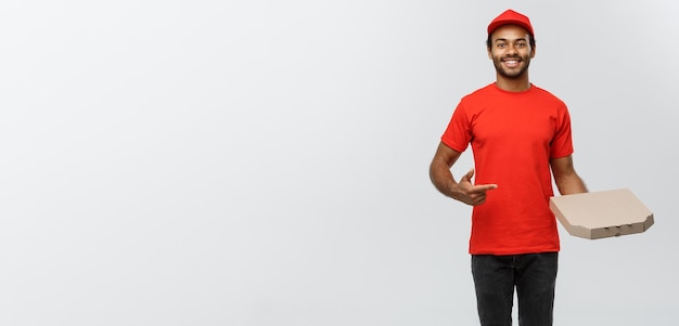 Delivery Concept Portrait of Handsome African American Pizza delivery man Isolated on Grey studio Background Copy Space