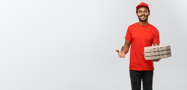 Delivery Concept Portrait of Handsome African American Pizza delivery man Isolated on Grey studio Background Copy Space