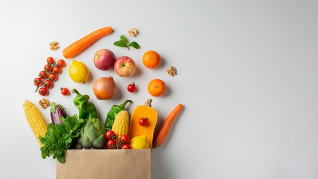 Delivery healthy food background Healthy vegan vegetarian food in paper bag vegetables and fruits on white copy space banner Shopping food supermarket and clean vegan eating concept