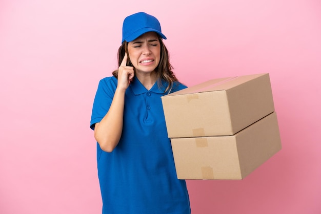 Delivery Italian woman isolated on pink background frustrated and covering ears