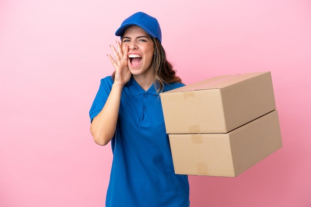 Delivery Italian woman isolated on pink background shouting with mouth wide open