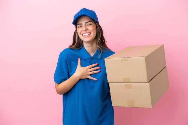 Delivery Italian woman isolated on pink background smiling a lot