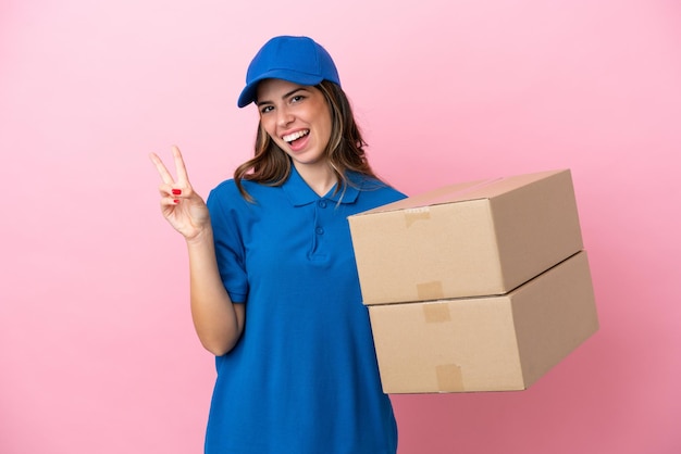 Delivery Italian woman isolated on pink background smiling and showing victory sign