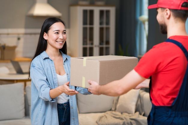 Delivery man giving order to woman