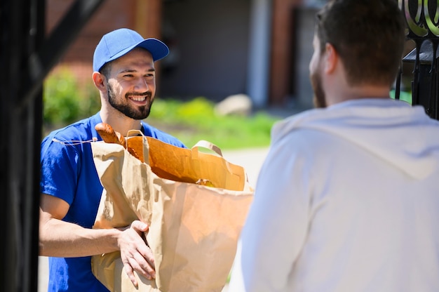 Delivery man happy to hand out groceries to customer