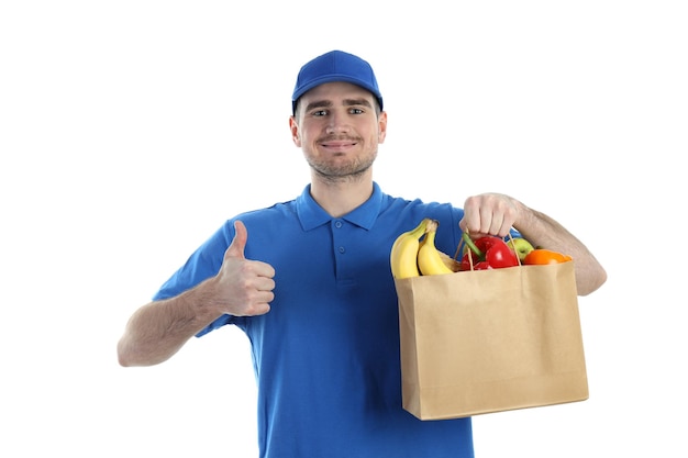 Delivery man holds bag with food, isolated on white background