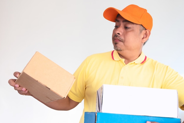 Delivery Man in Orange Cap and Yellow Shirt Carrying Parcel Post Box Sending to Recipient