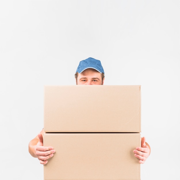 Delivery man standing with two big boxes 