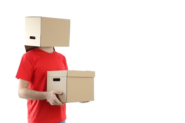 Delivery man with a box on his head and in the hands, isolated on white background