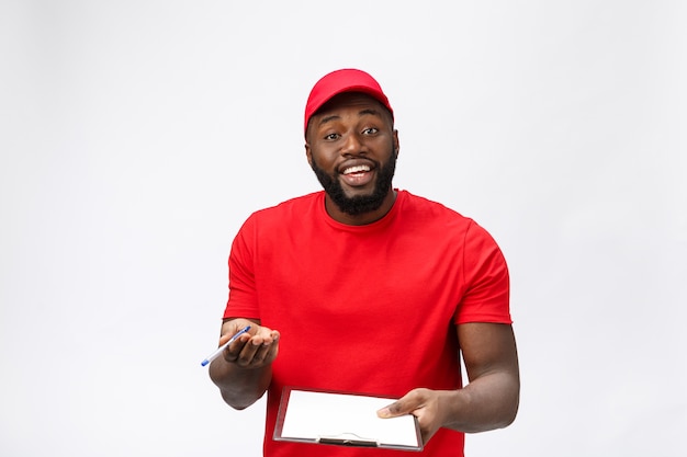 Delivery service - Portrait of Handsome African American delivery man or courier showing a confirmation document form to sign.  