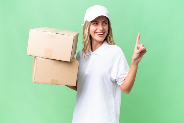 Delivery Uruguayan woman over isolated background pointing up a great idea