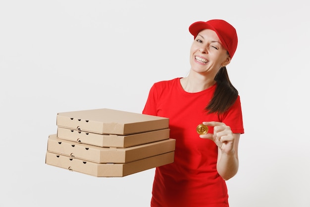 Delivery woman in red cap, t-shirt giving food order italian pizza in cardboard flatbox boxes isolated on white background. Female pizzaman working as courier holding bitcoin, coin of golden color.