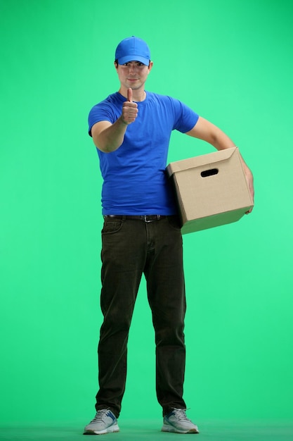 The deliveryman in full height on a green background shows a thumbs up