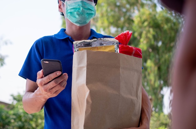 Deliveryman re-check orders from phone and deliver food to customer. food online delivery