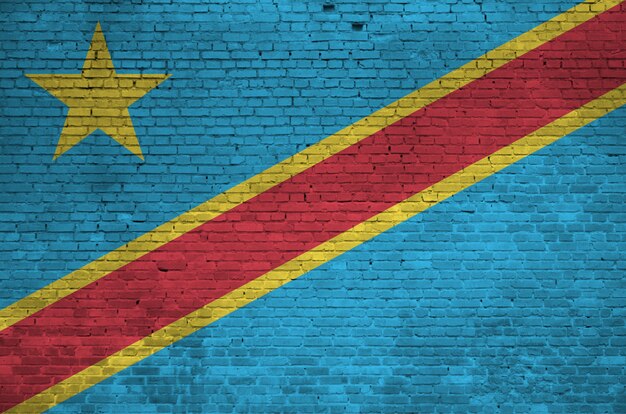 Democratic Republic of the Congo flag depicted in paint colors on old brick wall. Textured banner on big brick wall masonry background