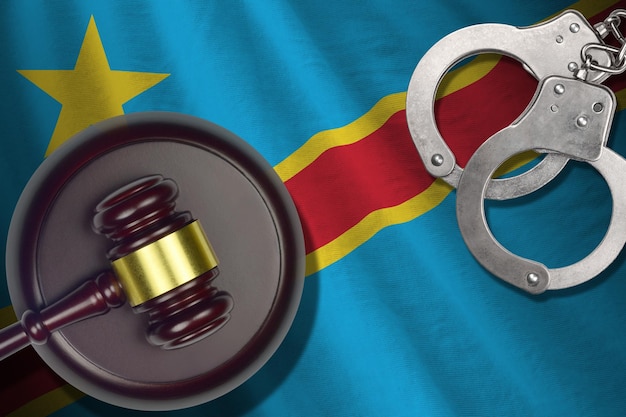 Democratic Republic of the Congo flag with judge mallet and handcuffs in dark room Concept of criminal and punishment background for judgement topics