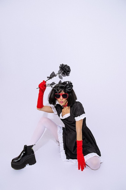 Demonic gothic stylish brunette Lady posing in white studio