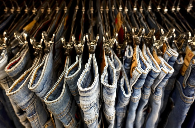 Denim trousers on hangers