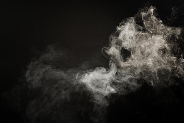 Dense Fluffy Puffs of White Smoke and Fog on Black Background, Abstract Smoke Clouds, Movement Blurred out of focus. Smoking blows from machine dry ice fly and fluttering in Air, effect texture