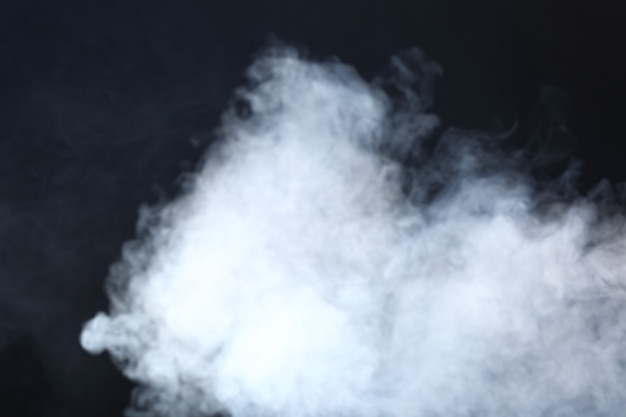 Dense Fluffy Puffs of White Smoke and Fog on Black Background, Abstract Smoke Clouds, Movement Blurred out of focus