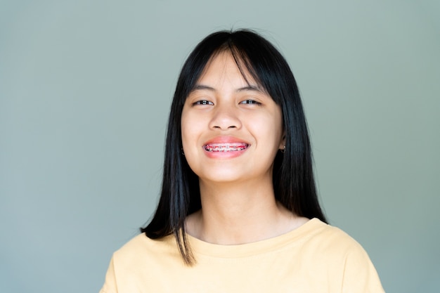 Dental Brace Girl Smiling and Looking to Camera, She Feel Happy and Have Good Attitude with Dentist.  Motivate Kids not Fear When they have to go to Dental Clinic.