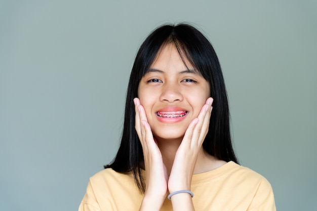 Dental Brace Girl Smiling and Looking to Camera, She Feel Happy and Have Good Attitude with Dentist.  Motivate Kids not Fear When they have to go to Dental Clinic.